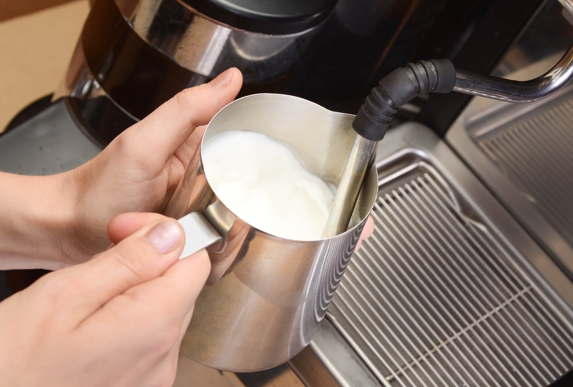Home Milk Frothing Equipment and someone who frothing milk for coffee